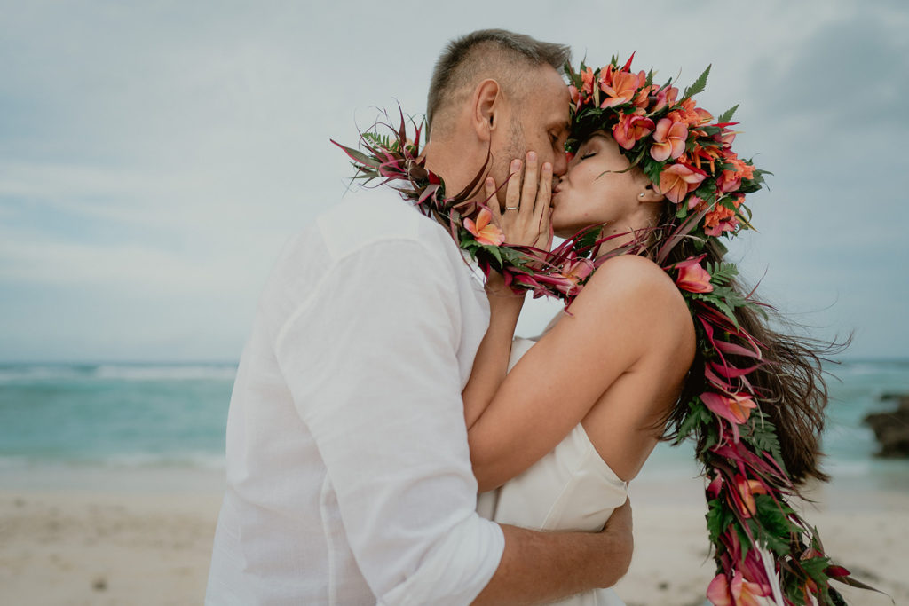 Couple kissing to celebrate their tropical beach elopement