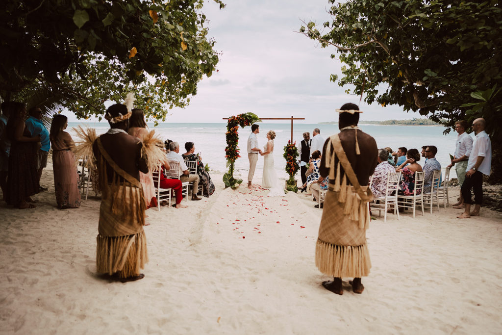 A wedding ceremony on Erakor Island in Vanuatu with tropical flowers and warriors in custom outfits